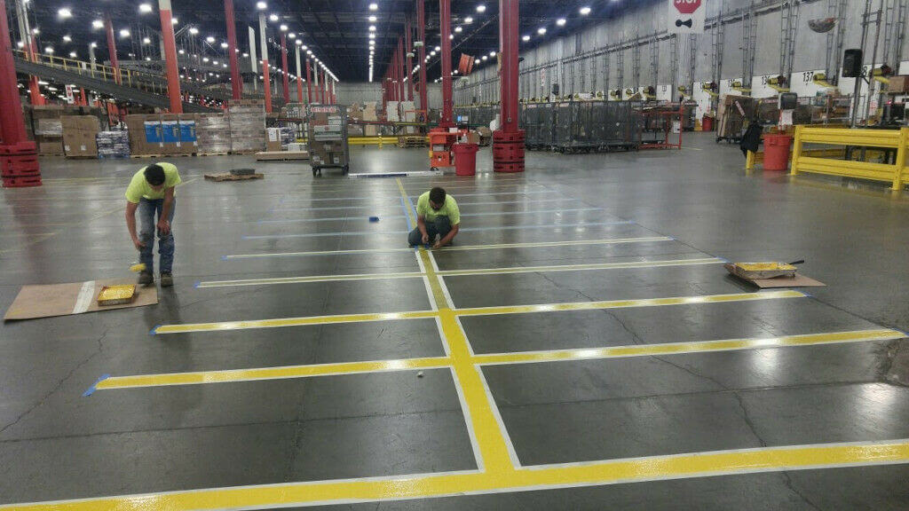Evercor workers painting warehouse lines