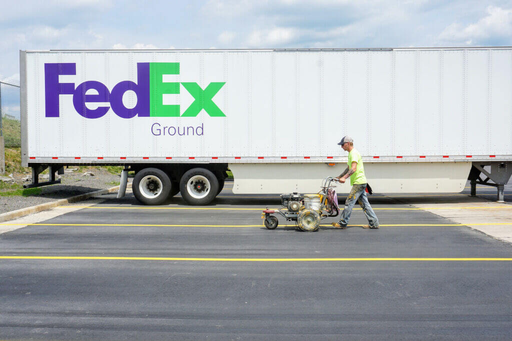 Evercor worker painting trailer parking lines